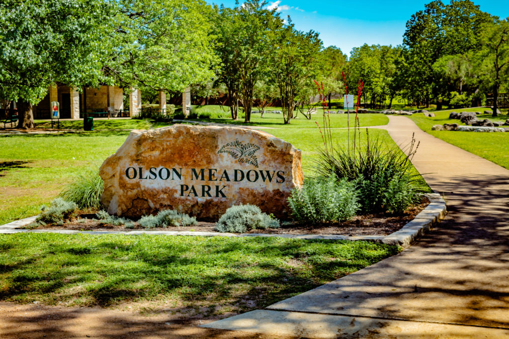 Picture of a large rock with the park name on it at Olson Meadows Park.
